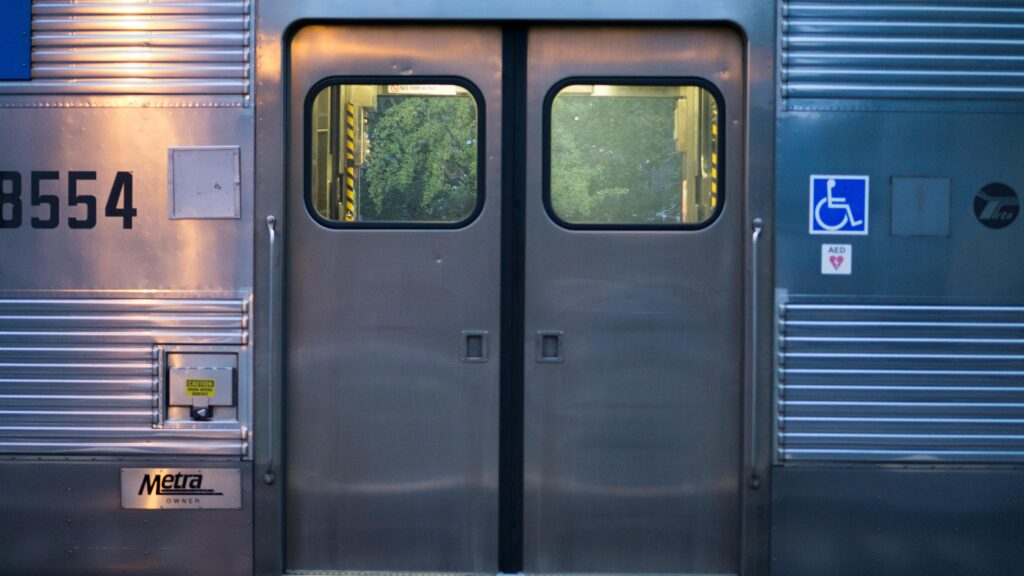 Passenger train outside. Close up of door. Wheelchair symbol.